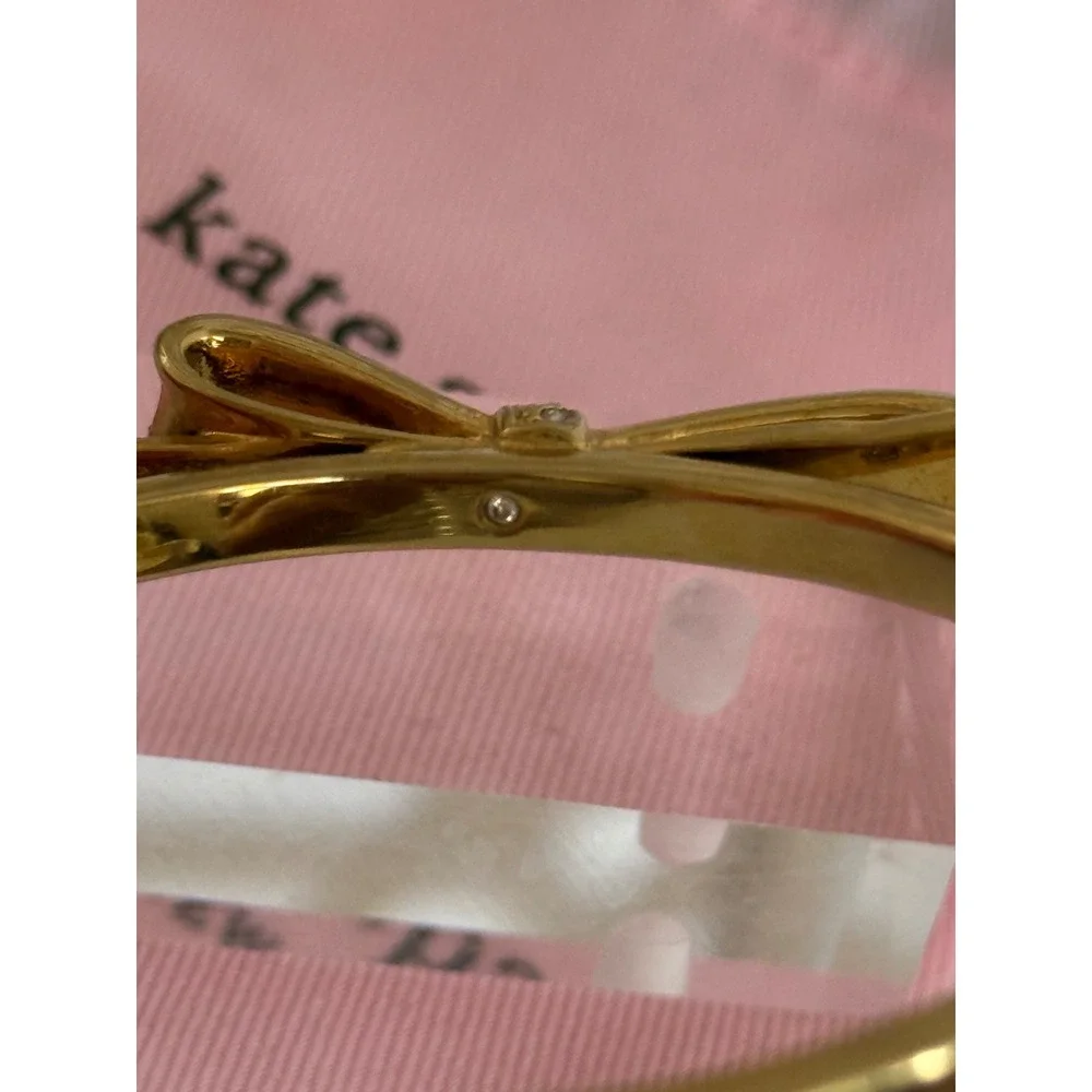 Kate Spade New York Gold Tone Pave Crystal Bow Hinged Bangle Bracelet with Bag